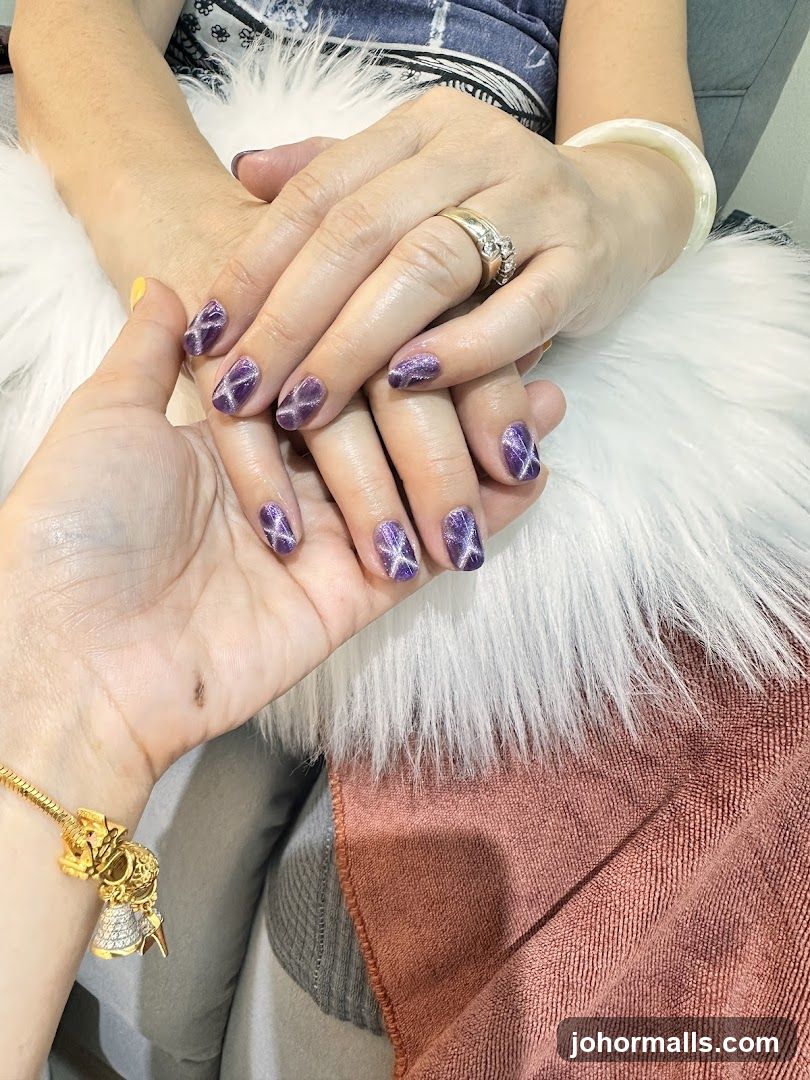 Manicured Hands with Purple Glitter Nails