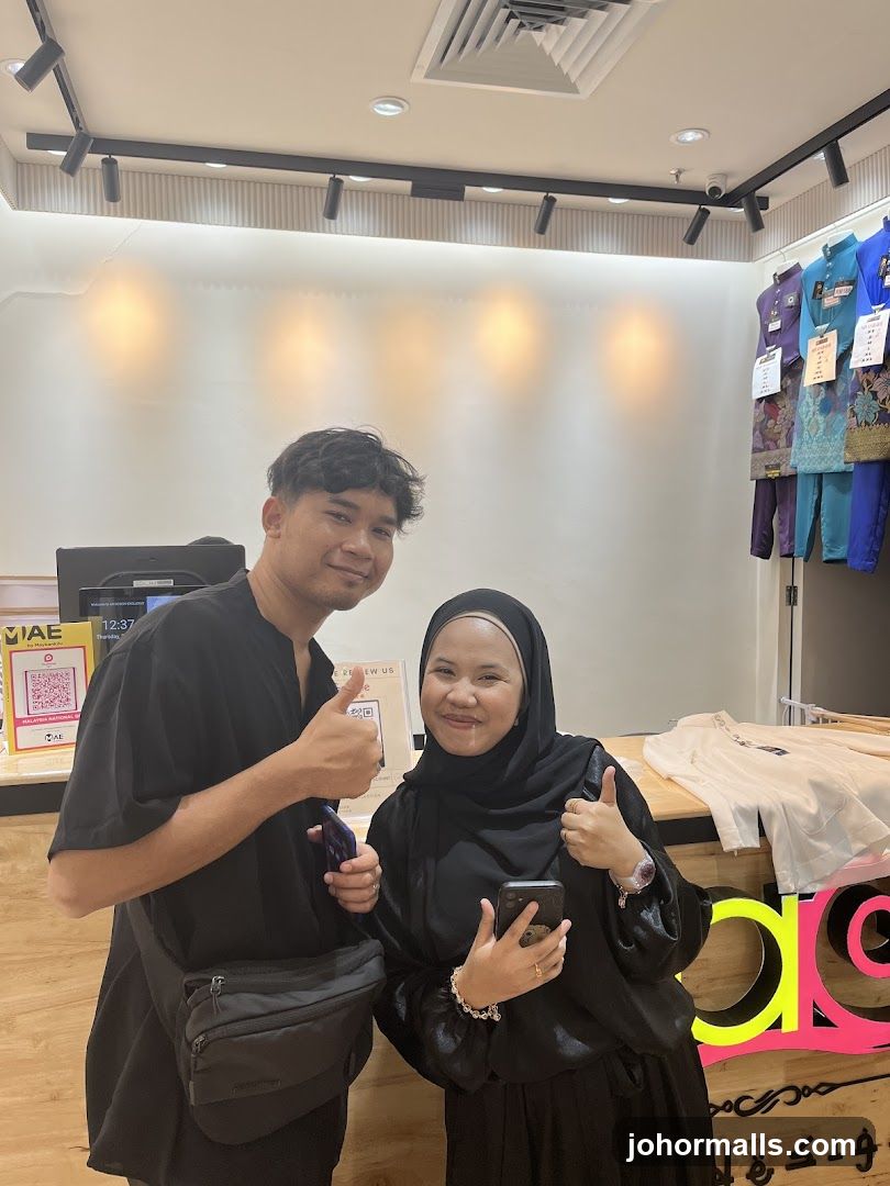 Two people giving thumbs up in a store
