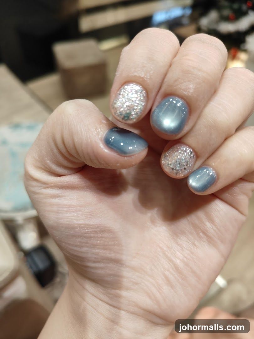 Nails with Glitter and Blue Polish