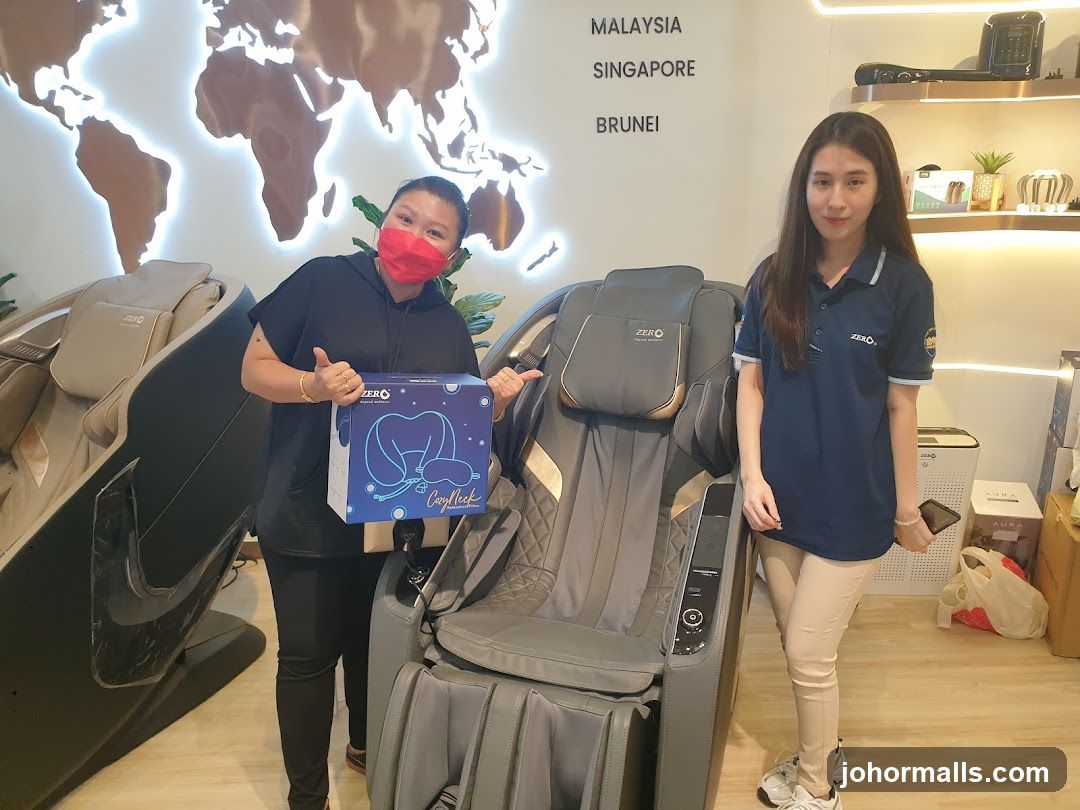 Two women with massage chairs and a product box