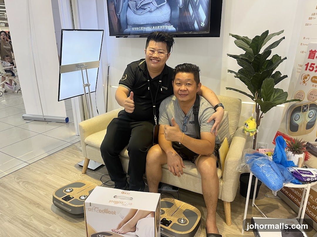Two men posing with massage devices