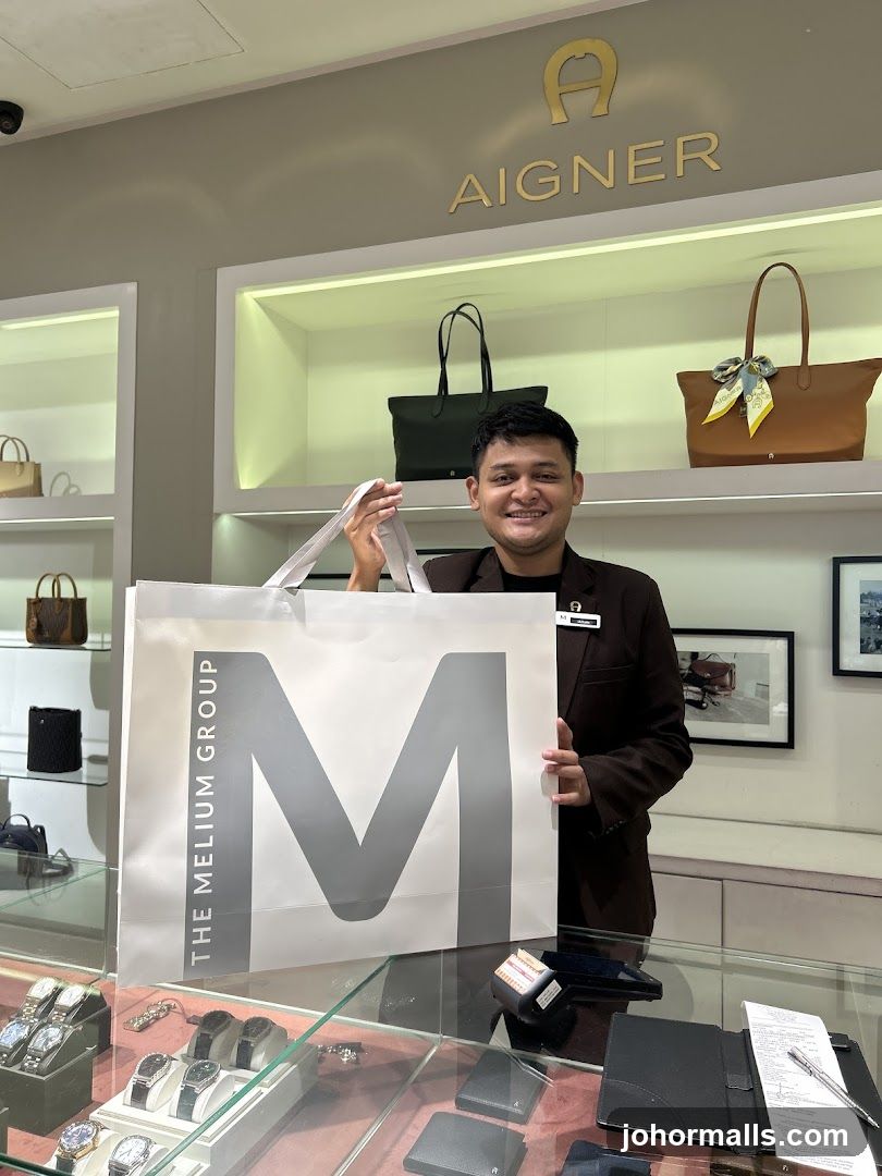 Man holding a shopping bag in a store