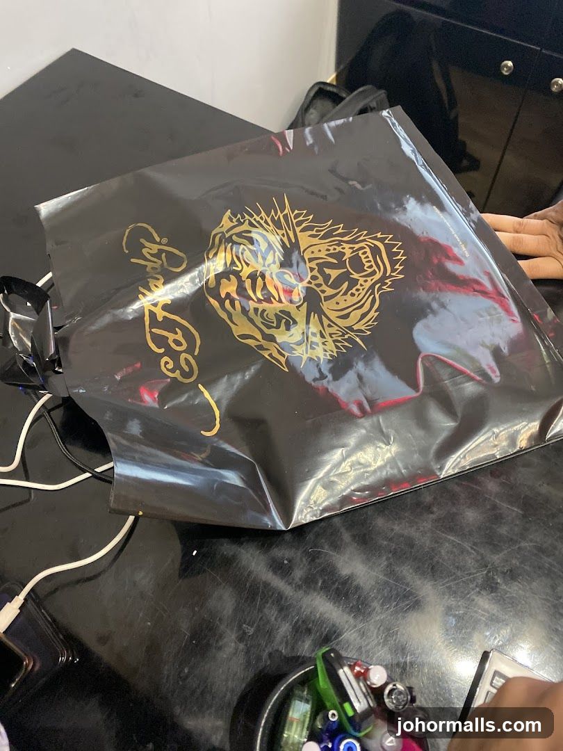Black shopping bag with gold tiger graphic