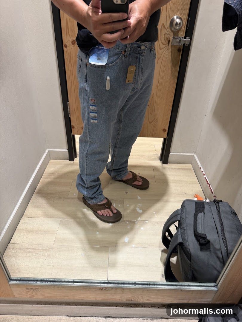 Person trying on jeans in a fitting room
