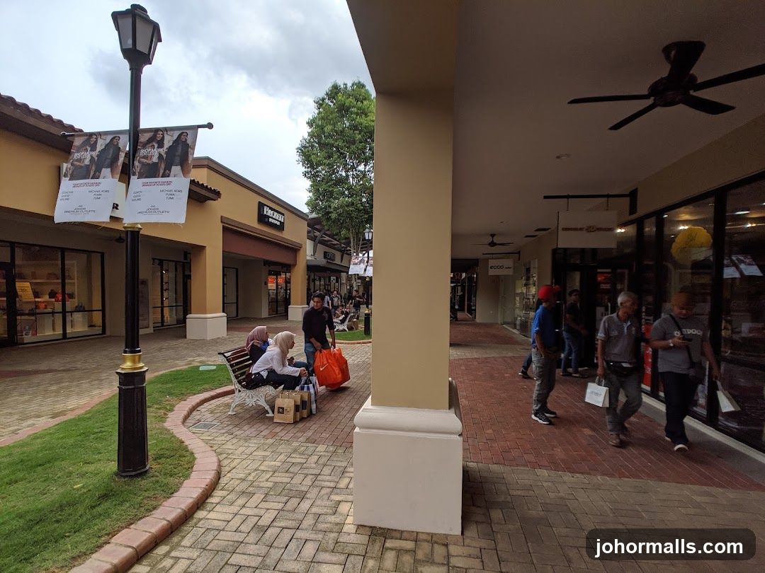 Outdoor shopping mall with storefronts and people