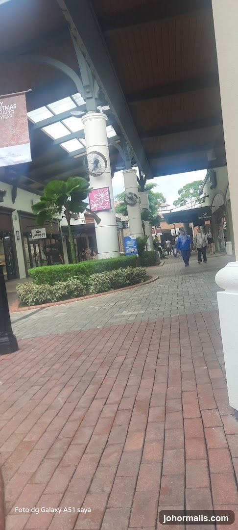 Outdoor shopping area with shops and people