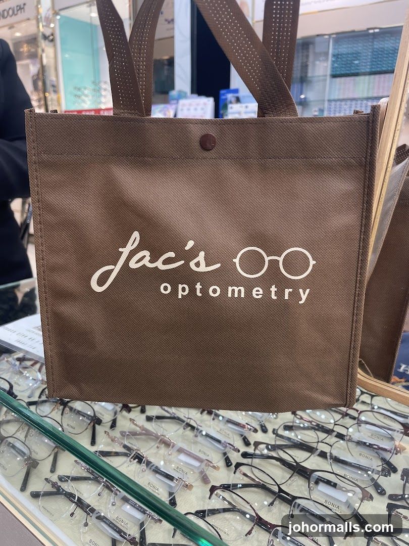 Brown tote bag with "Jac's optometry" logo