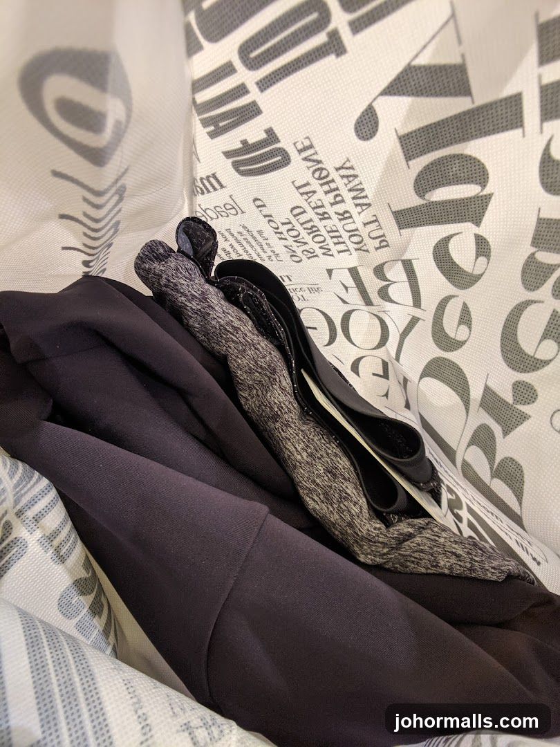 Folded dark clothing inside a branded bag