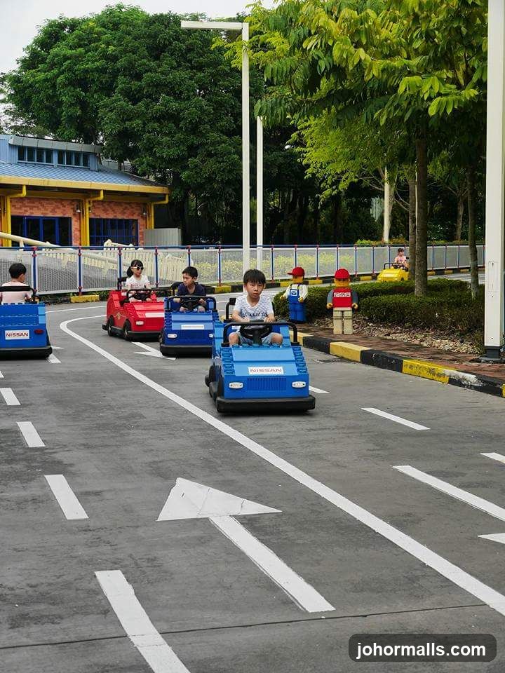 Children driving miniature cars on a road course