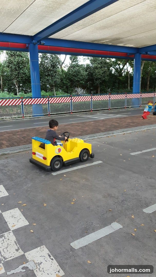 Child Driving a Lego Car