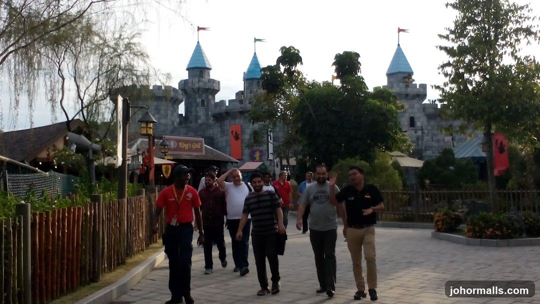 People walking past a castle-themed restaurant