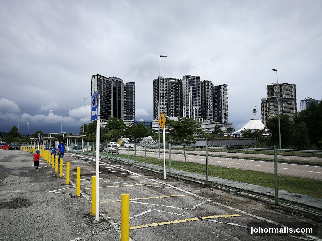 Parking lot with modern buildings in the background
