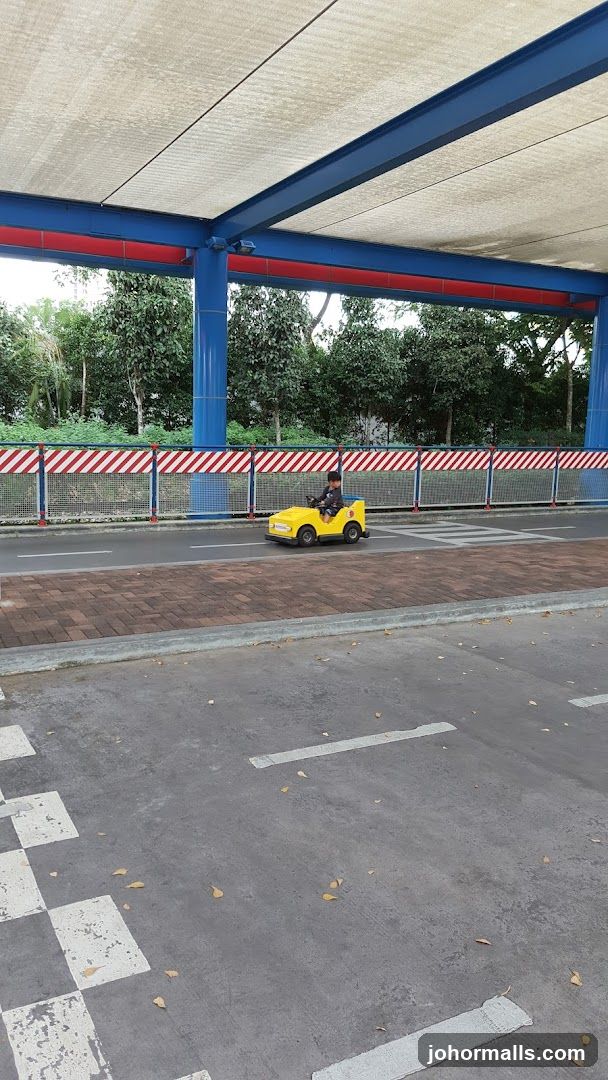 Child Driving a Toy Car