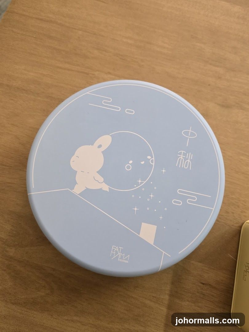 Round tin with rabbit and moon design