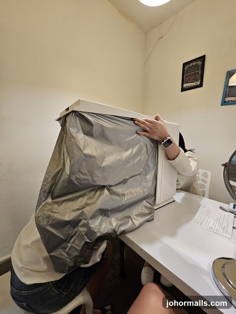 People interacting with a device covered by a silver tarp