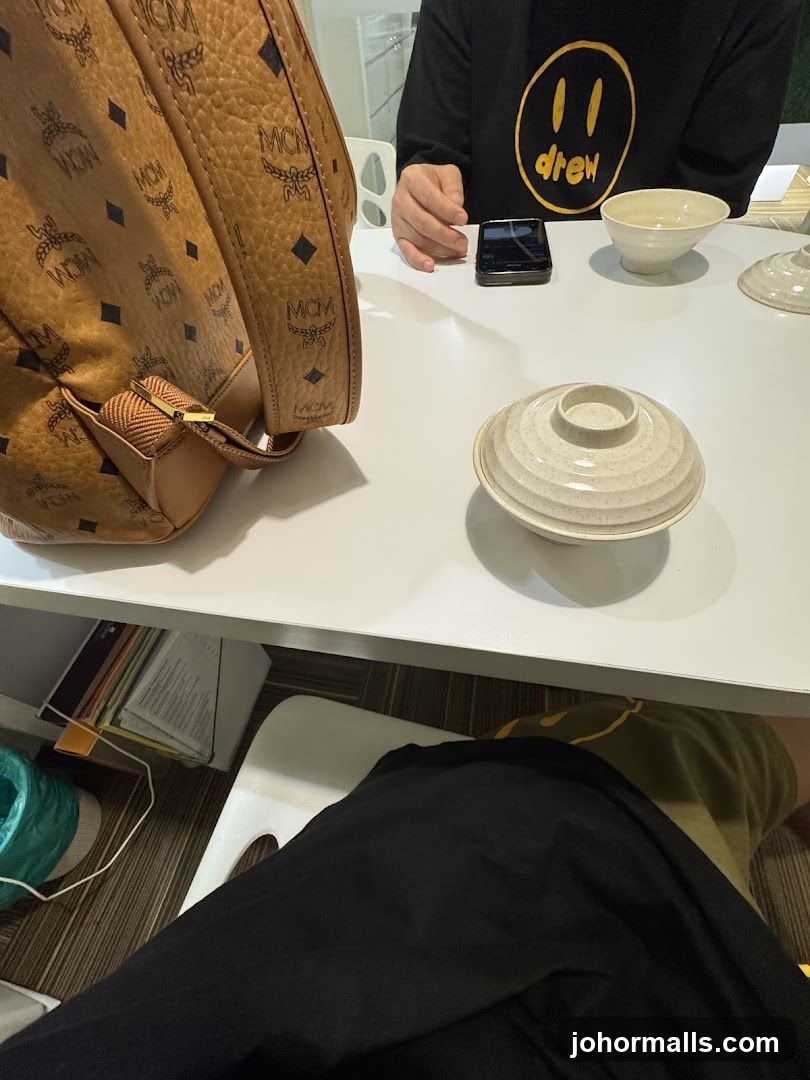 Table with MCM Backpack and Drew House Sweatshirt