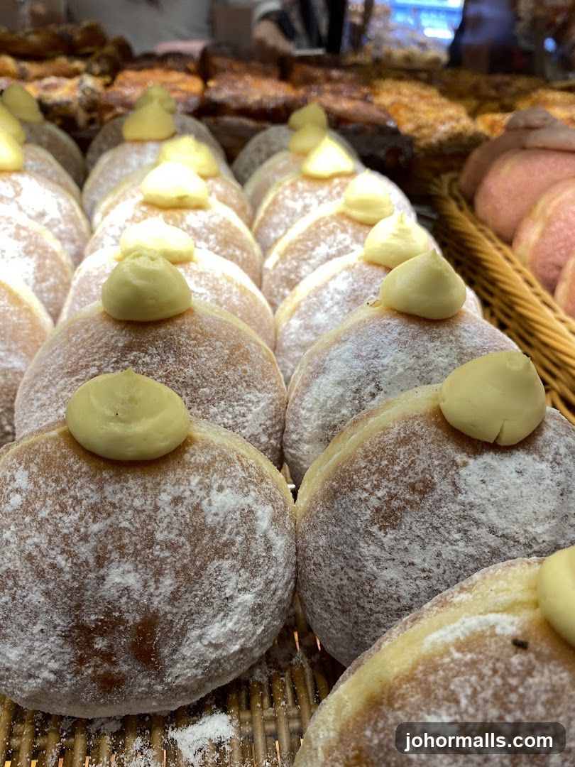 Cream-filled donuts dusted with powdered sugar