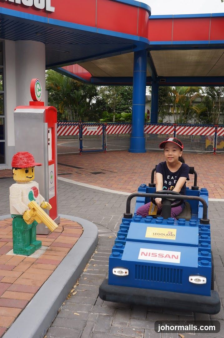 Child in Lego Car at Gas Station