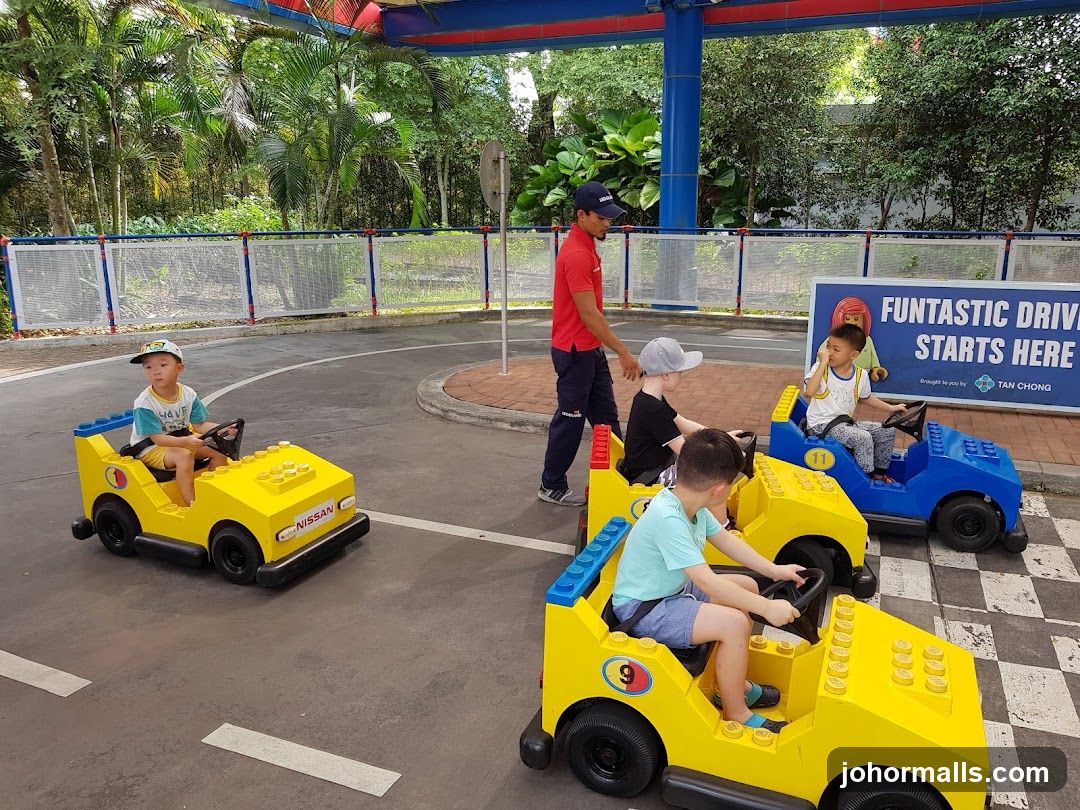 Children driving Lego cars