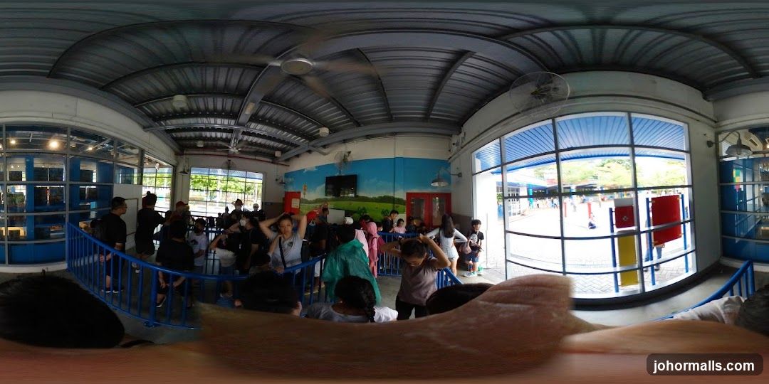 People waiting in a covered area with a mural