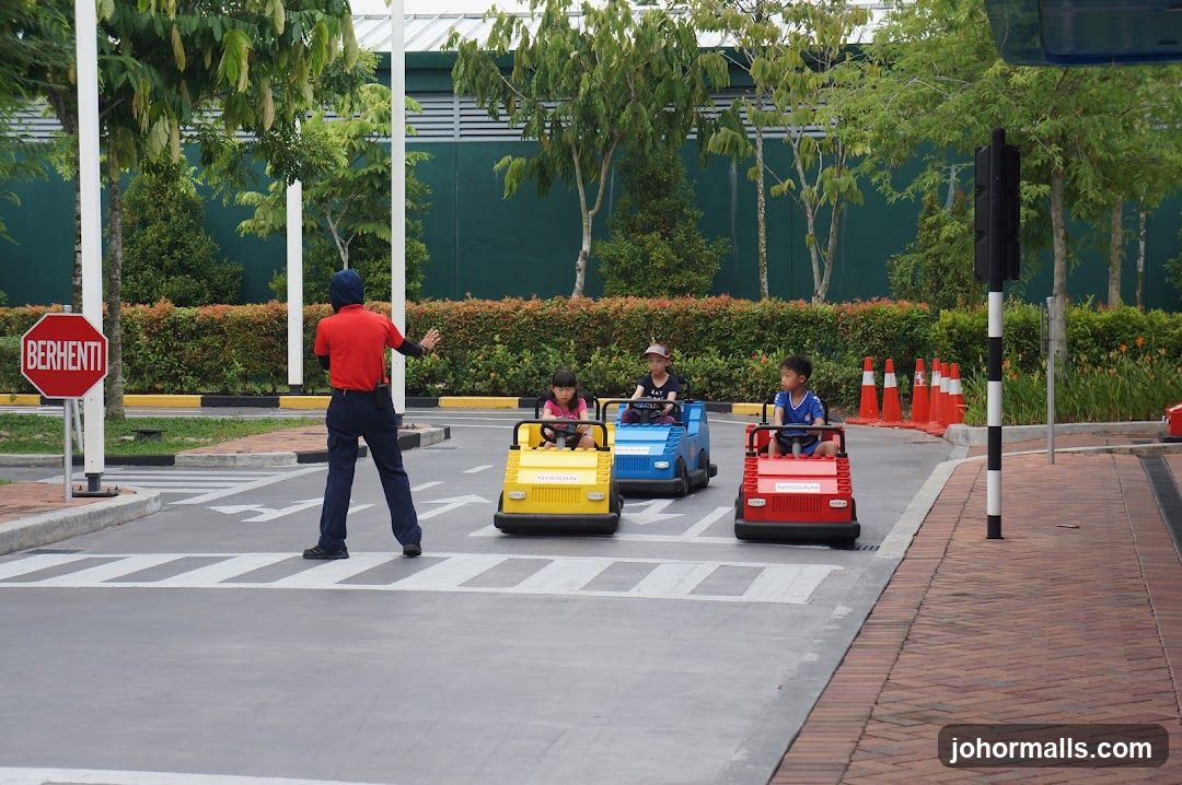 Children driving miniature cars at a traffic safety park