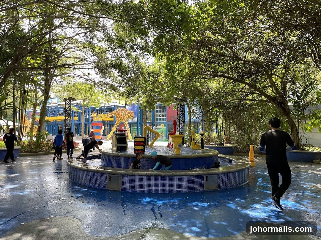 Children playing in a water park with giraffe decorations