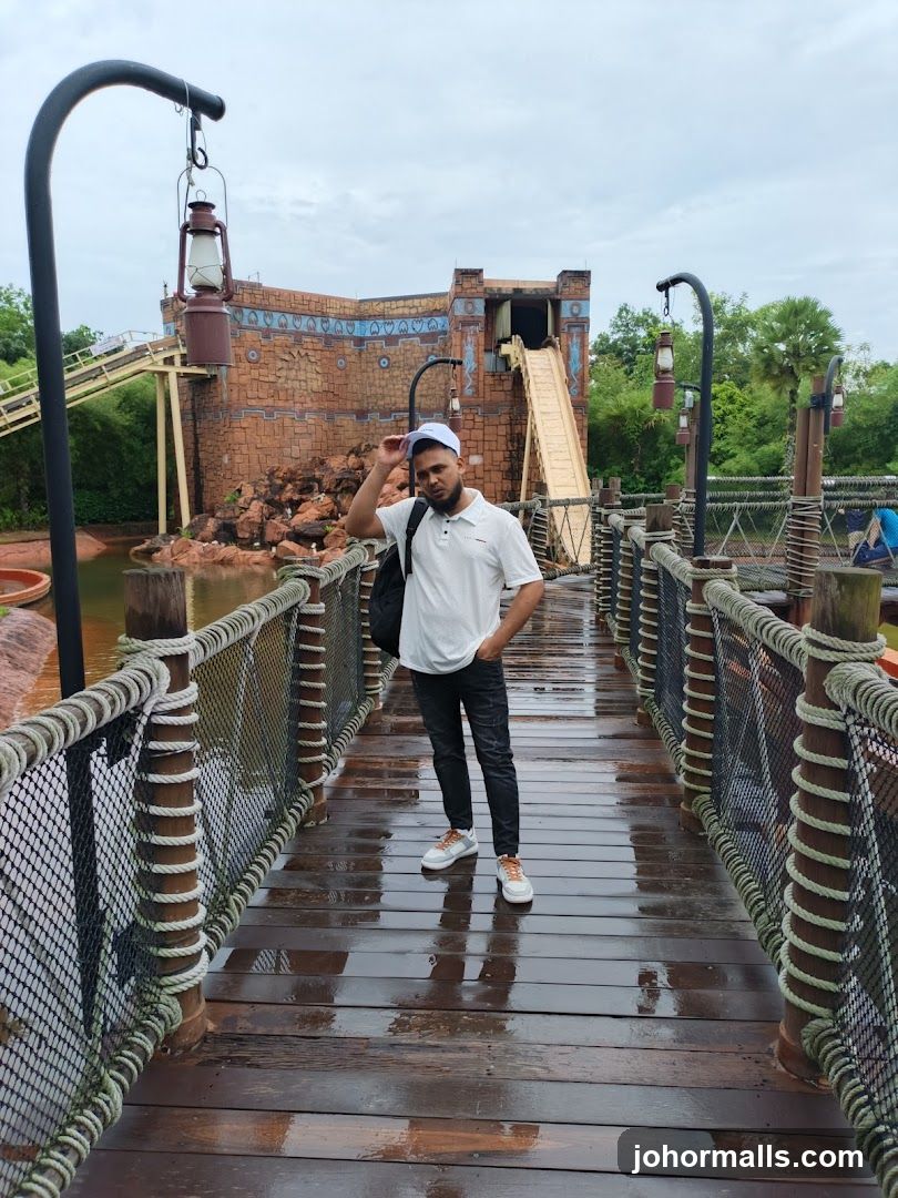 Man on a Wooden Bridge at an Amusement Park