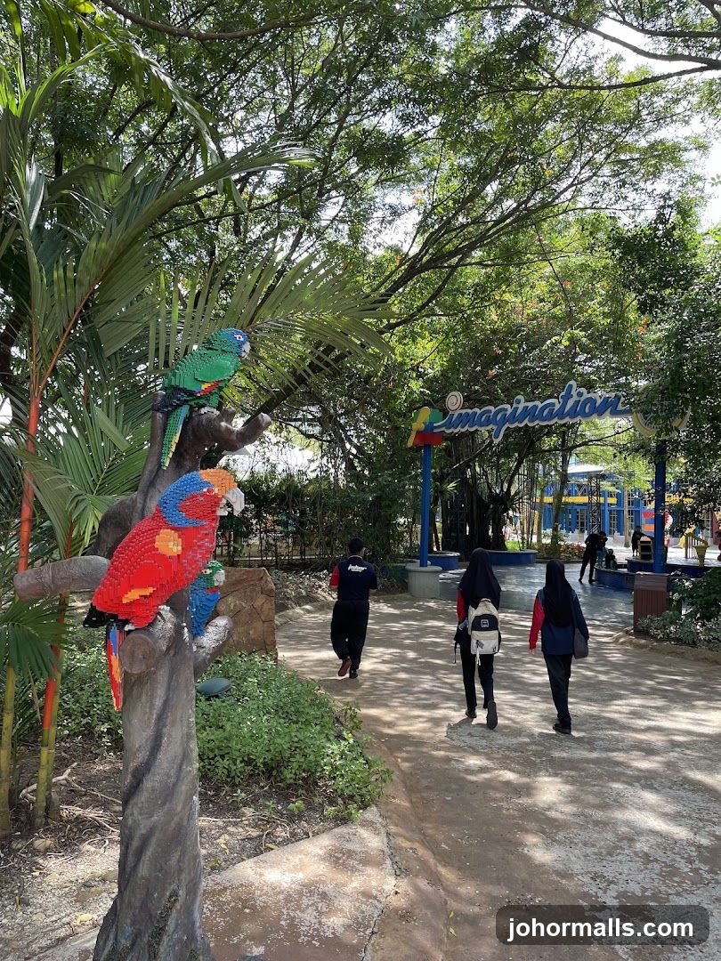 Park pathway with Lego parrots and "Imagination" sign