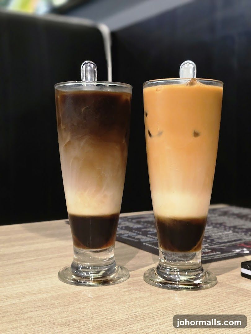 Two layered iced drinks on a table