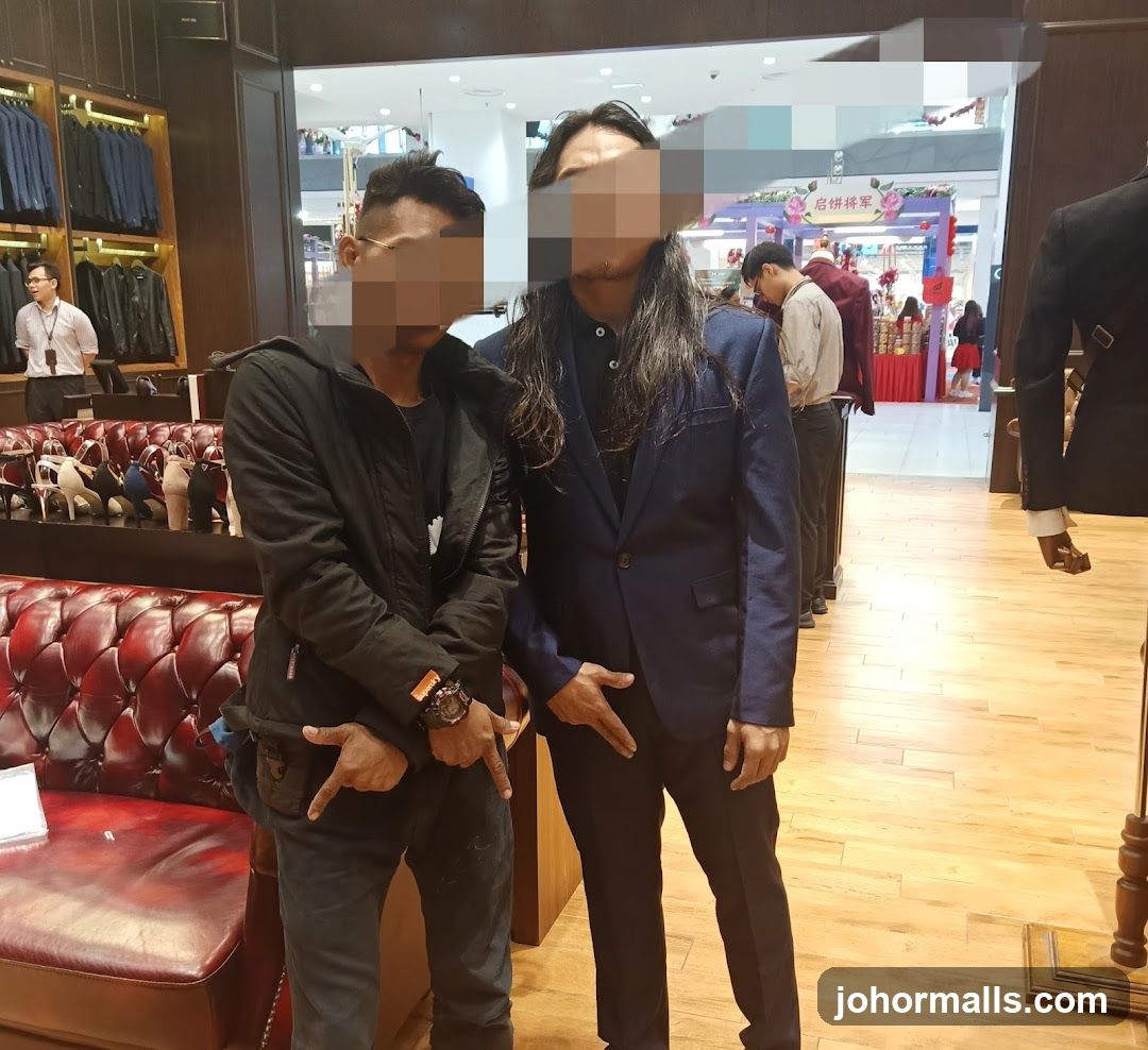 Two men posing in a store
