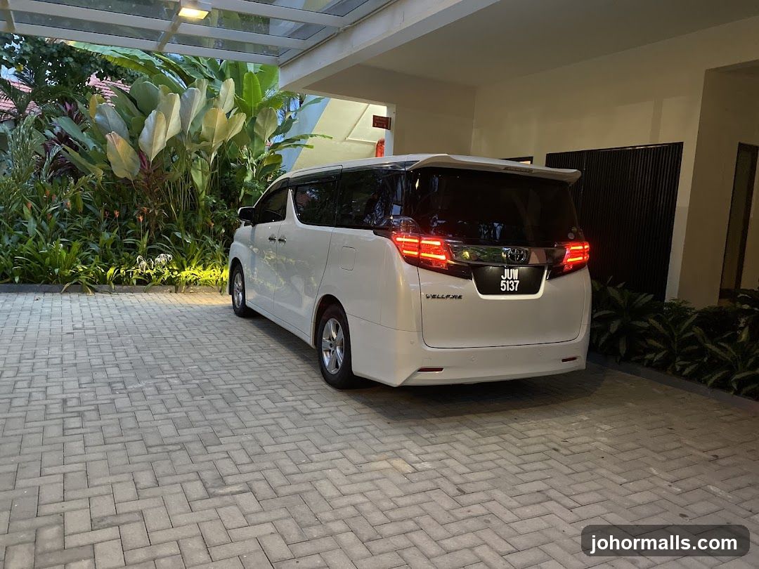 White minivan parked under a covered driveway