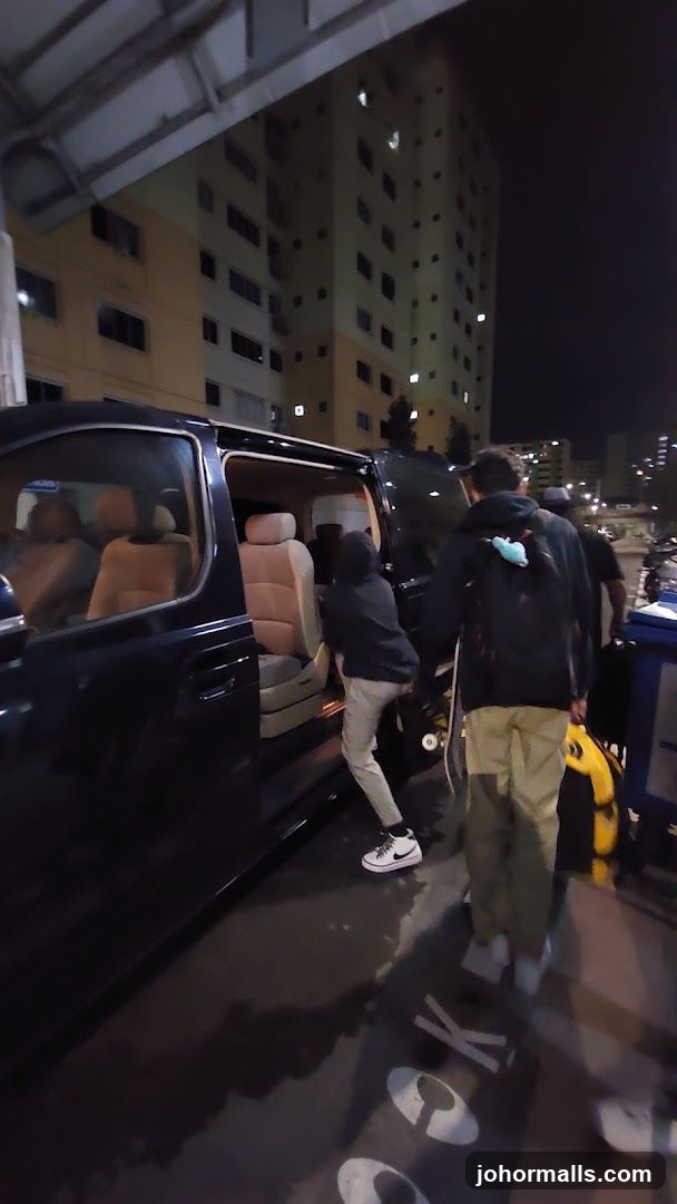 People boarding a van at night