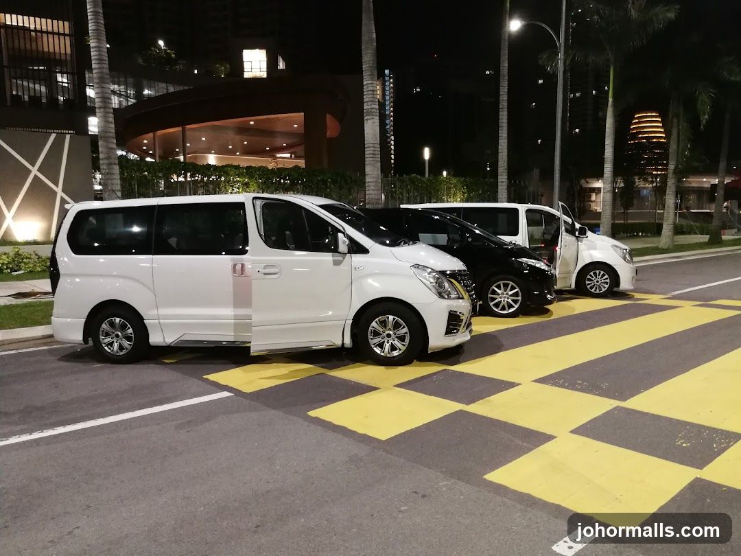 Vans parked on a street at night