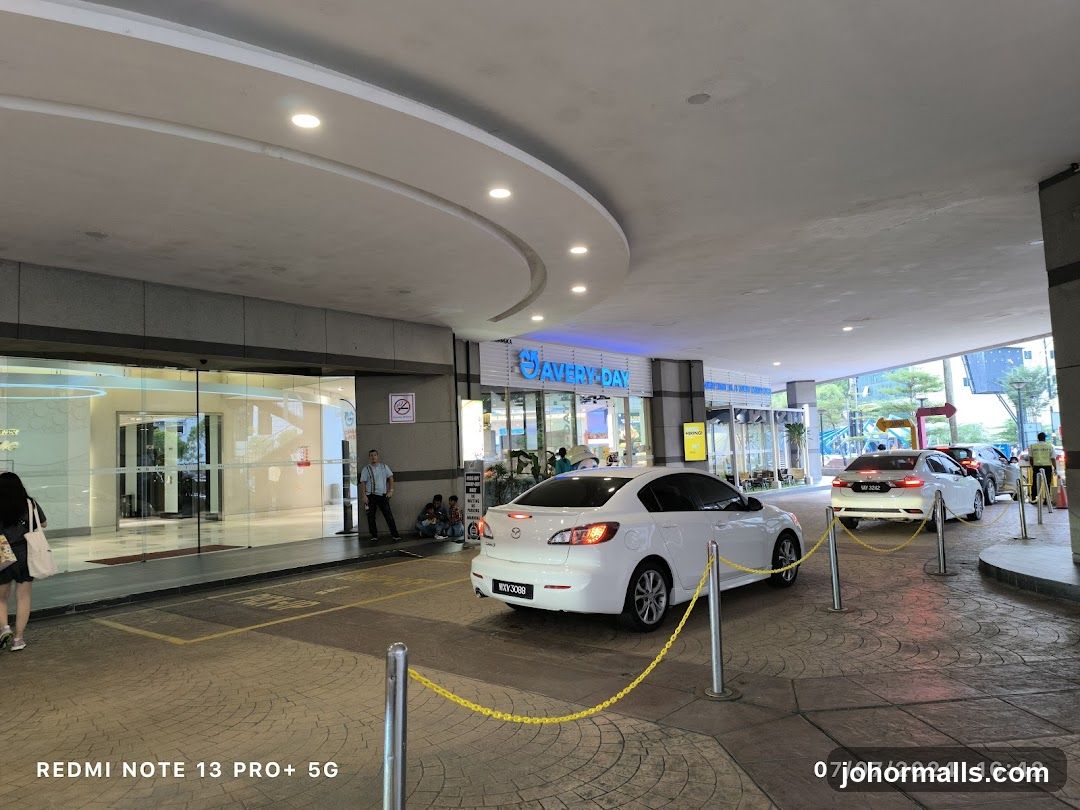 Cars waiting in a queue outside a building