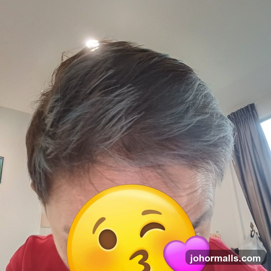 Person with emoji covering face