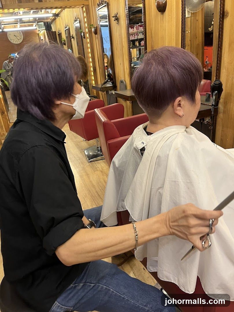 Hairdresser cutting client's hair