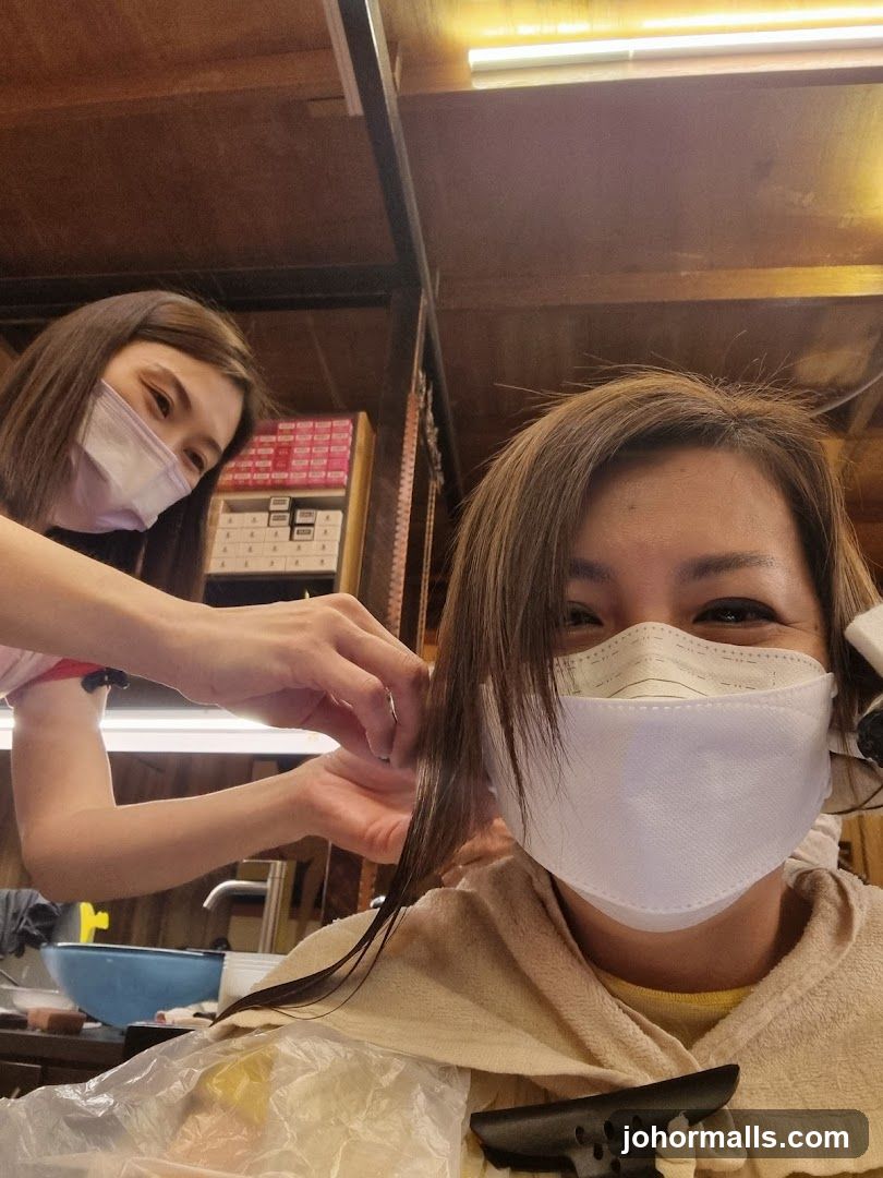Hairdresser cutting client's hair