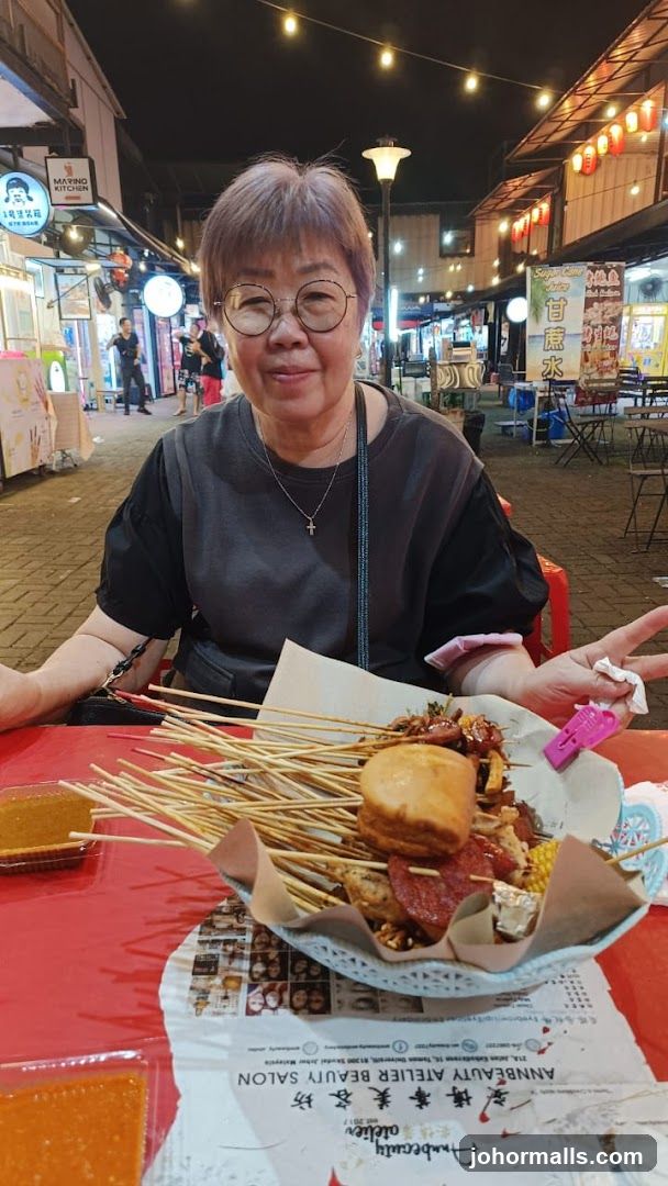 Woman with skewers of food