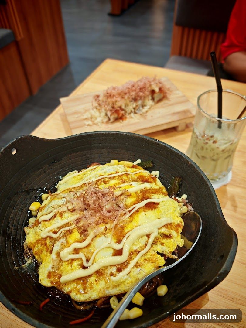 Omurice with a side of sushi and a drink