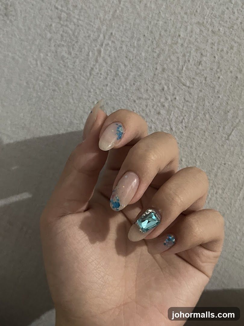 Nails with Blue Glitter and Gemstones