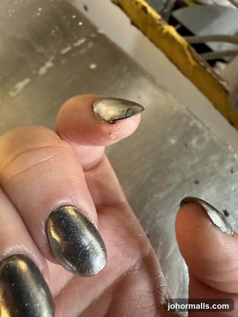 Close-up of a cracked fingernail