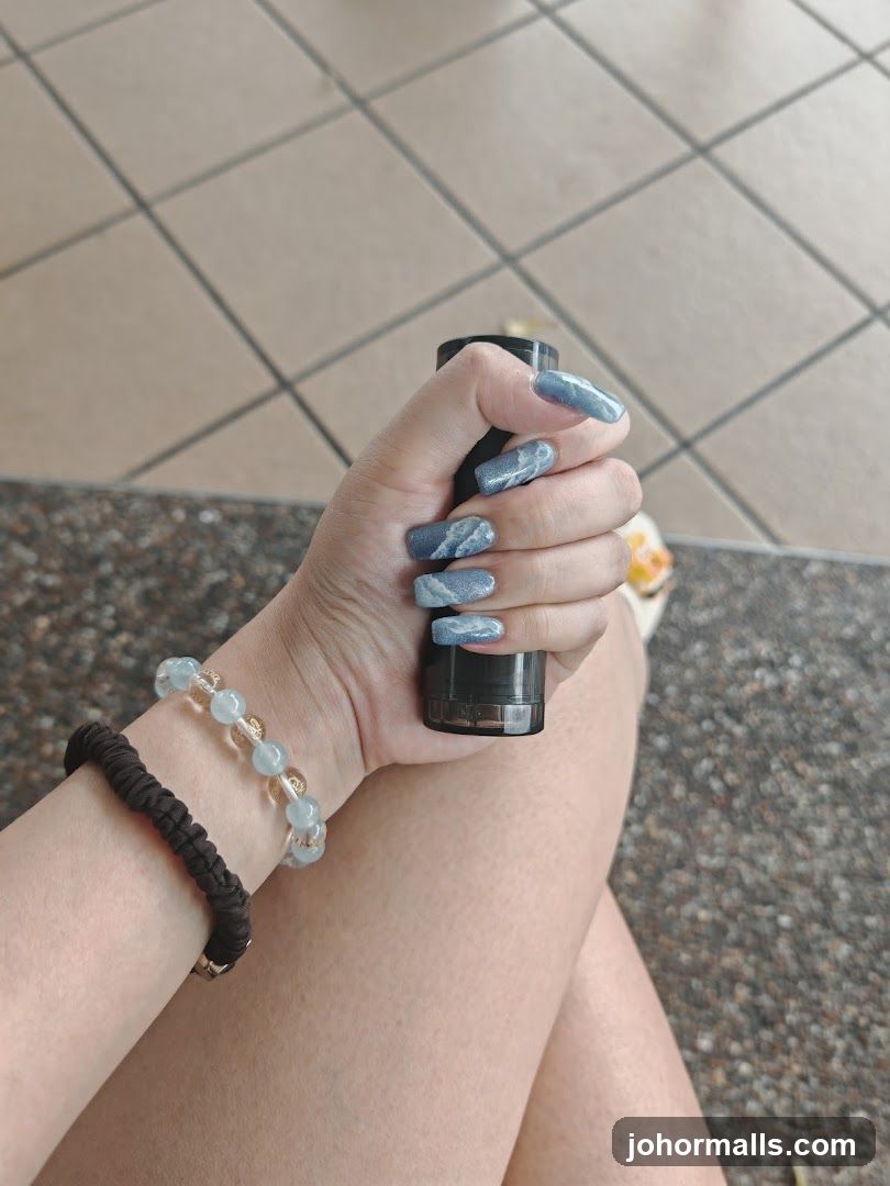 Woman's hand holding a black object