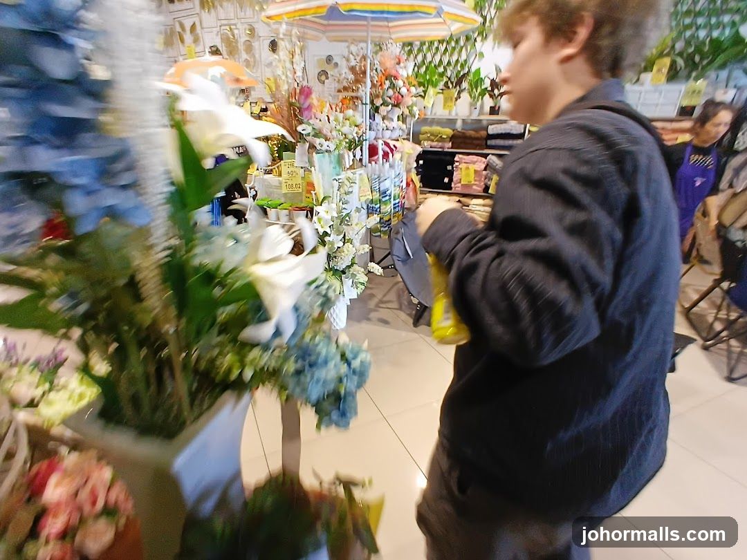 Person holding a yellow bottle in a store