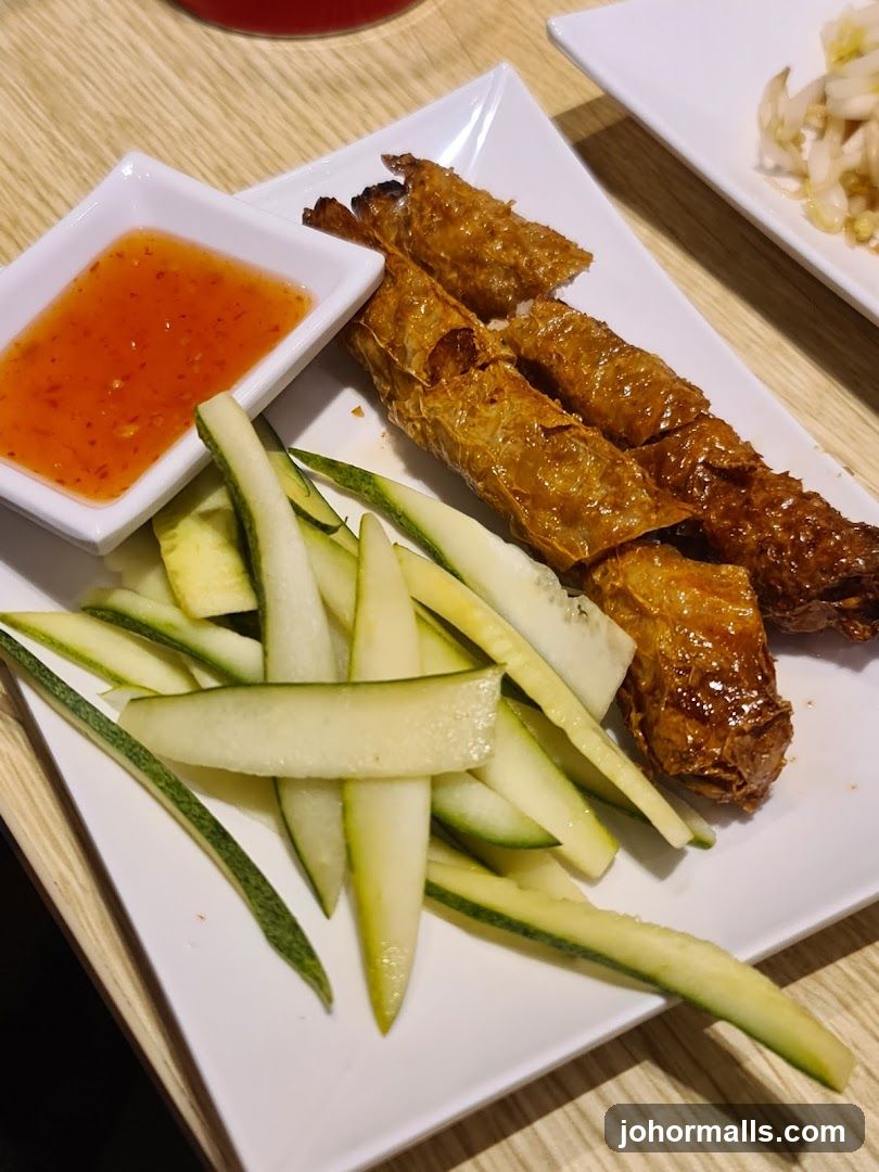 Fried Rolls with Dipping Sauce and Cucumber Slices