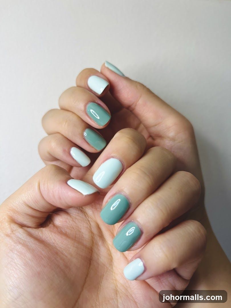 Hands with mismatched nail polish