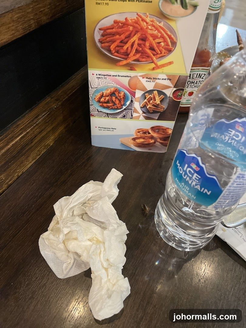 Menu items and water bottle on table