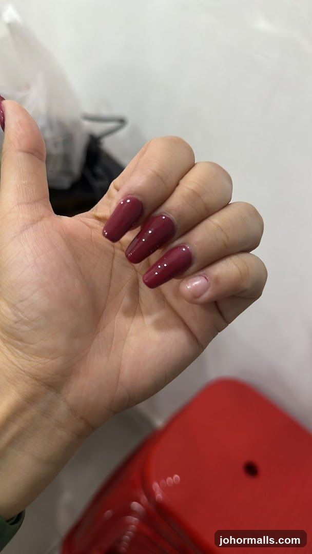 Woman's Hand with Burgundy Nails