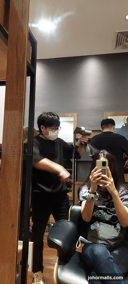Hairdresser drying client's hair