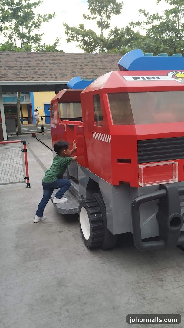 Child climbing on a Lego fire truck