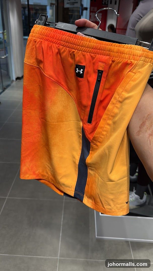 Orange and yellow gradient shorts with black zipper pocket